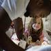 Faith Falzon of Dexter smiles, hugs a signed teddy bear and looks up at former University of Michigan football player Charles Woodson as he signs a hat for her May 19 at C.S. Mott Children's Hospital. "I have something to show you," Faith later said, motioning a thumbs down while saying "Michigan State."
Jeffrey Smith | AnnArbor.com